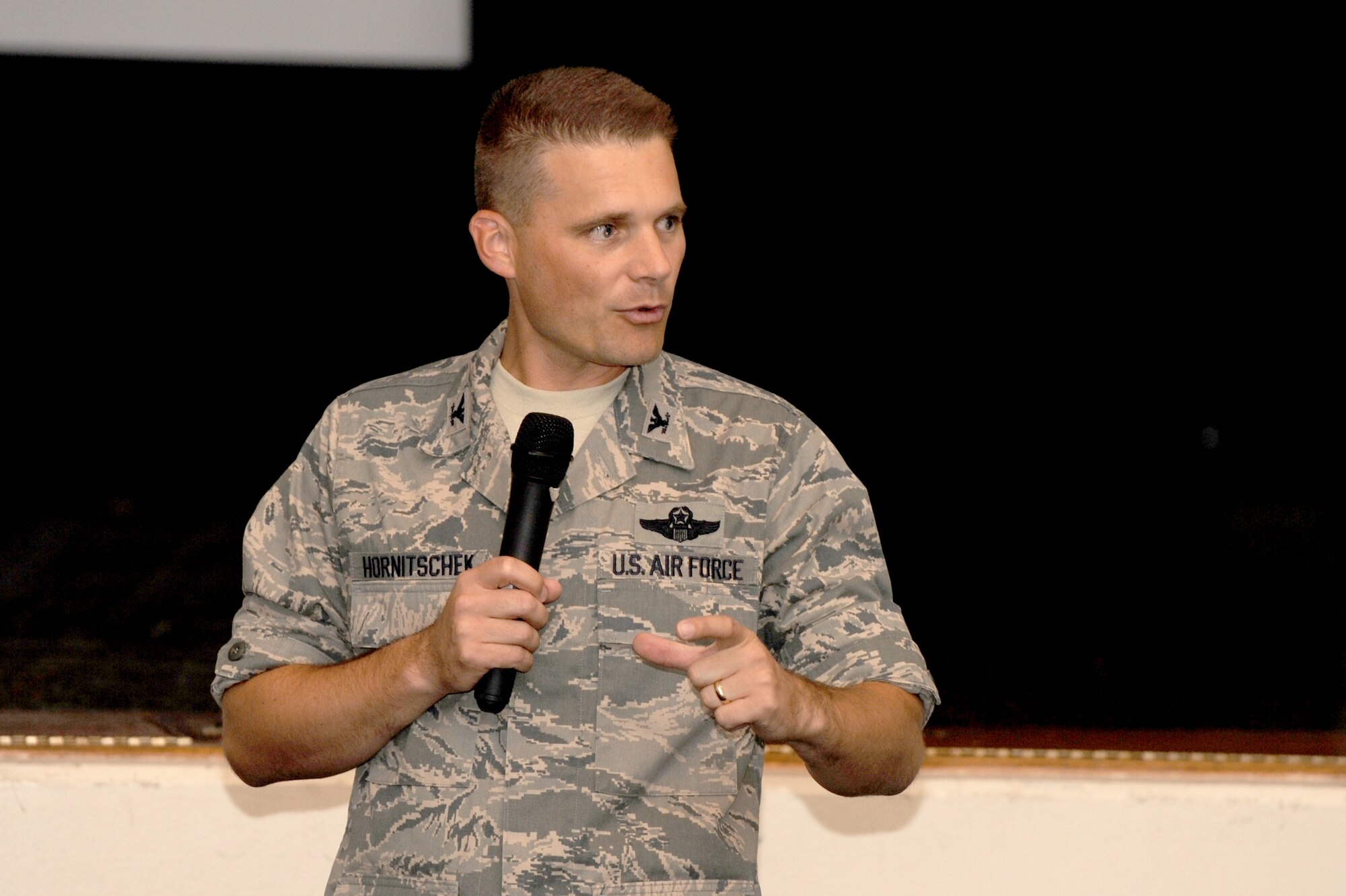 SCOTT AIR FORCE BASE, Ill. -- Col. Michael Hornitschek, 375th Air Mobility Wing commander, speaks to Airmen from the wing during a commander’s call Aug. 31. Members of 375th AMW were reminded to stay safe over the Labor Day weekend, keep up on fitness, pursue educational goals and safeguard against phishing and spear-phishing attempts. Colonel Hornitschek placed special emphasis on being a good Wingman in light of the recent increase of suicides across the Air Force, encouraging Airmen to look out for and recognize risk factors. (U.S. Air Force photo/Staff Sgt. Brian Valencia)