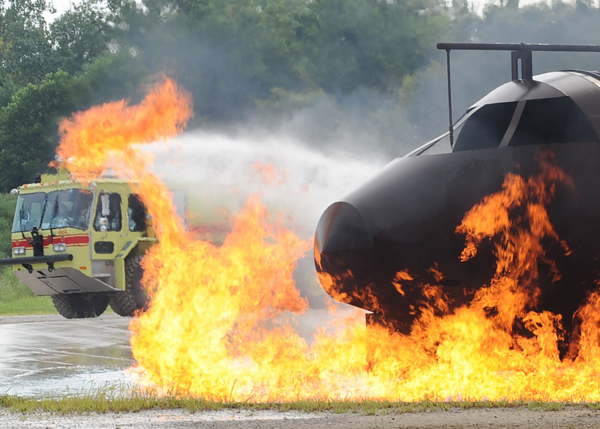 SCOTT AIR FORCE BASE, Ill. -- A fire truck from the 375th Civil Engineer Squadron Fire Department responds to a training exercise fire Aug. 12 during a Live Fire Certification test. The exercise helps firefighters learn what to expect during a real emergency and what actions are most affective in different scenarios. (U.S. Air Force Photo/Senior Airman Tristin English)