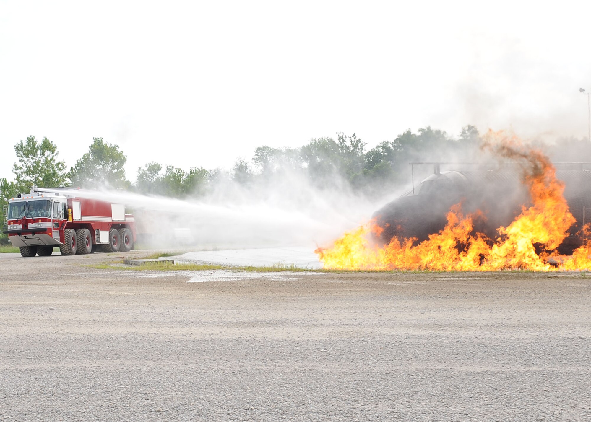 SCOTT AIR FORCE BASE, Ill. -- A fire truck from the 375th Civil Engineer Squadron Fire Department responds to a training exercise fire Aug. 12 during a Live Fire Certification test. The exercise helps firefighters learn what to expect during a real emergency and what actions are most affective in different scenarios. (U.S. Air Force Photo/Senior Airman Tristin English)