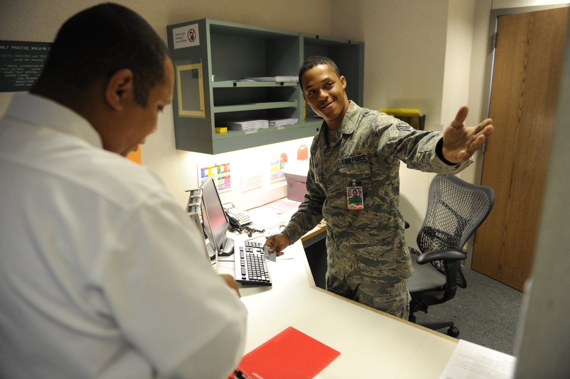 SCOTT AIR FORCE BASE, Ill. -- Senior Airman Aaron Lacour, 375th Medical Operations Squadron administration technician at Belleville Family Medicine Clinic, checks a patient in Aug. 31. The clinic is supported by 19 medical technicians and eight administration technicians comprised of active duty, civilian and contract employees assigned to Scott Air Force Base. (U.S. Air Force photo/Staff Sgt. Ryan Crane) 