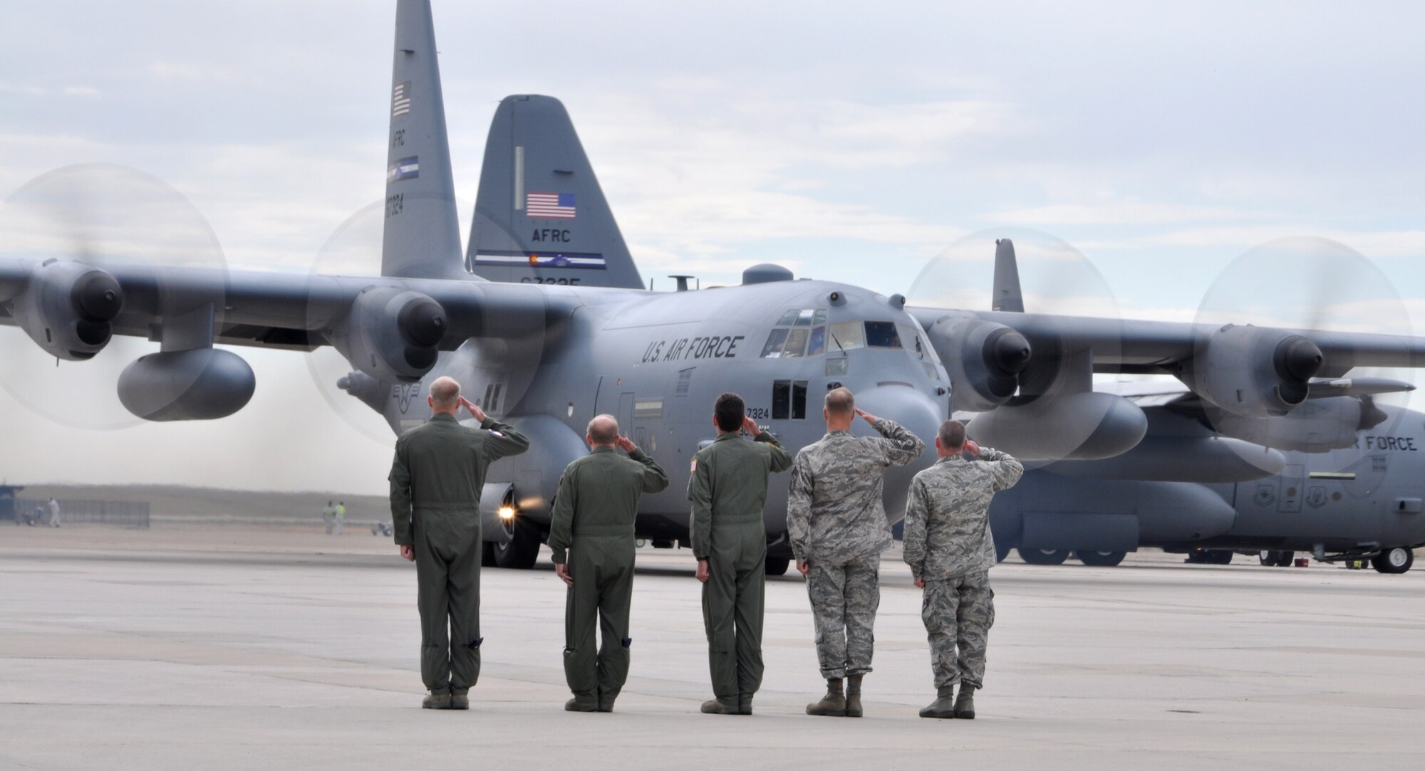Col. Jay Pittman (far right) and senior 302nd Airlift Wing leadership salute Sept. 8 as the last of four C-130 Hercules taxis for takeoff at Peterson Air Force Base, Colo. The aircraft, one of three that departed Peterson AFB today, contained Air Force Reservists who are deploying in support of U.S. Central Command operations in the Middle East. More than 150 aircrew, maintenance and support AF Reservists from the 302nd AW will take part in this airlift support deployment package. The 302nd AW is an AF Reserve unit based at this southern Colorado installation. (U.S. Air Force photo/Staff Sgt. Stephen J. Collier)