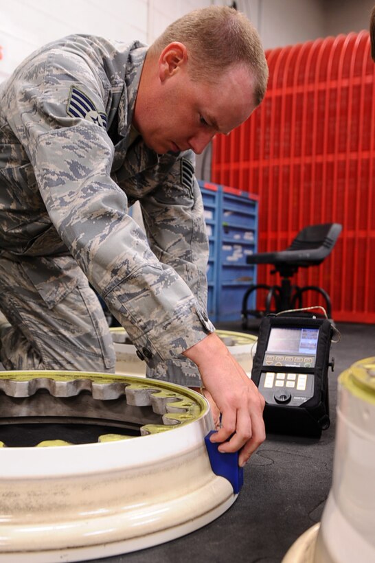 ELLSWORTH AIR FORCE BASE, S.D. - Staff Sgt. Brandon Roel, 28th Maintenance Squadron non-destructive inspection technician, conducts a routine inspection on a B-1B Lancer’s main landing gear wheel Sept. 2. Sergeant Roel is looking for any cracks that may have occurred during landings. (U.S. Air Force photo/Senior Airman Kasey Close)