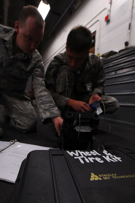 ELLSWORTH AIR FORCE BASE, S.D. - Staff Sgt. Brandon Roel (left), 28th Maintenance Squadron non-destructive inspection technician, and Senior Airman Evan Bryant (right), 28 MXS NDI technician, calibrates Eddy Current Equipment Sept. 2. After calibrating, Sergeant Roel and Airman Bryant will conduct a routine inspection on B-1B Lancer landing gear wheels. (U.S. Air Force photo/Senior Airman Kasey Close)