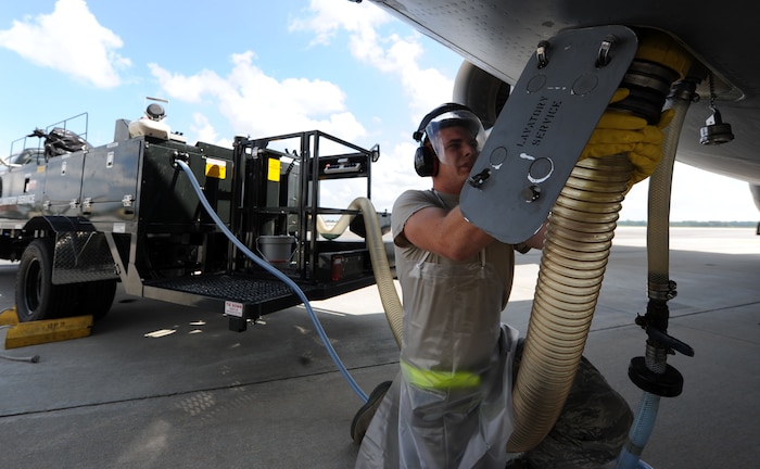 Airman 1st Class Jeffrey Montgomery connects the waste suction hose to the lavatory service outlet on the underbelly of a C-17 Globemaster III Sept. 7, 2010, on Joint Base Charleston, S.C. Airmen on lavatory service duty first pump water into the tank to break apart waste particles making the removal process smoother. Once the waste is removed, "Blue Juice" is pumped back into the system which is a cocktail comprised of water, anti-freeze and an anti-smell agent. Airmen service every C-17 upon landing and sometimes before take-off. Airman Montgomery is an air transportation technician with the 437th Aerial Port Squadron. (U.S. Air Force photo/Senior Airman Timothy Taylor)