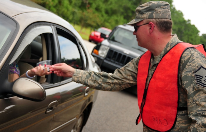 U.S. Air Force Master Sgt. Justin Taylor greets travelers exiting the Rivers Avenue Gate on Joint Base Charleston, S.C, Sept. 2, 2010. Sergeant Taylor was joined by fellow Team Charleston members as well as 437th Airlift Wing Commander Col. John Wood and 437 AW Command Chief Master Sgt. Terrence Greene in spreading the reminder to put safety first during the Labor Day holiday weekend. Sergeant Taylor is the weapons safety officer in charge for the 628th Air Base Wing Safety Office. (U.S. Air Force photo/Staff Sgt. Daniel Bowles)
