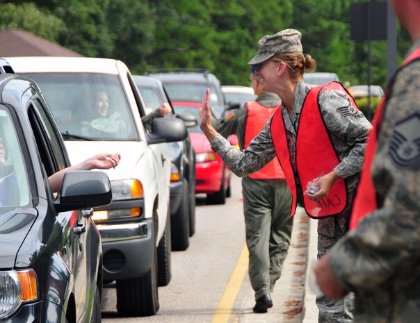 U.S. Air Force Staff Sgt. Amy Beamesderfer greets motorists exiting the Rivers Avenue Gate on Joint Base Charleston, S.C, Sept. 2, 2010. The sendoff was conducted to remind Team Charleston members embarking on the Labor Day holiday weekend to remain safety-minded. Sergeant Beamesderfer volunteered to participate in the safety sendoff for a one-hour shift, handing out safety whistles painted with the message "Safety ... Do it for the family." Sergeant Beamesderfer is a chaplain's assistant with the 628th Air Base Wing. (U.S. Air Force photo/Staff Sgt. Daniel Bowles)