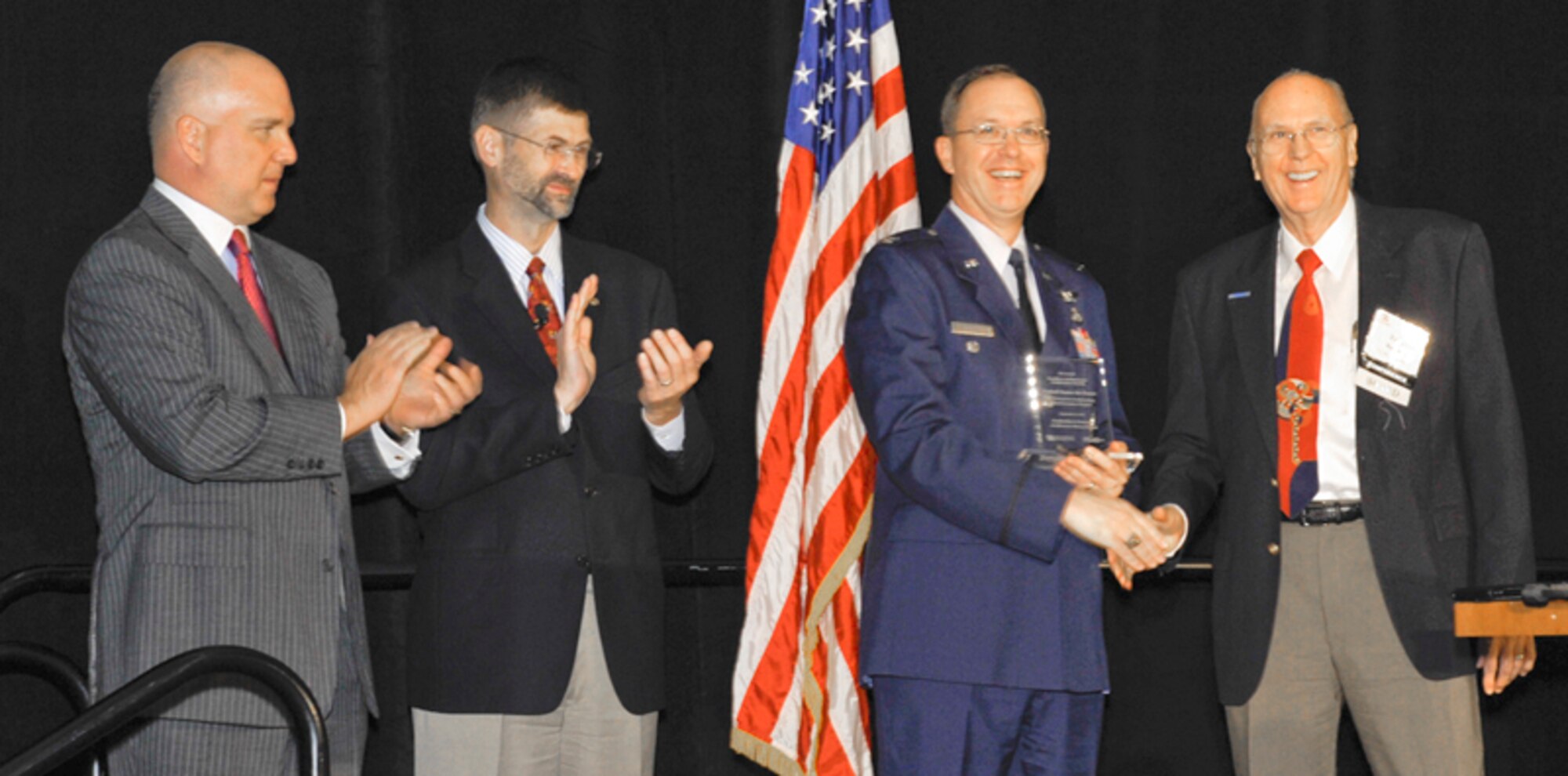 Representing the Air Force Enterprise Architecting Division, Col. David Geuting accepts an Excellence in Enterprise Architecture Award during the Enterprise Architecture 2010 Conference Sept. 8, 2010, in Washington D.C. (U.S. Air Force photo/Michael J Pausic)