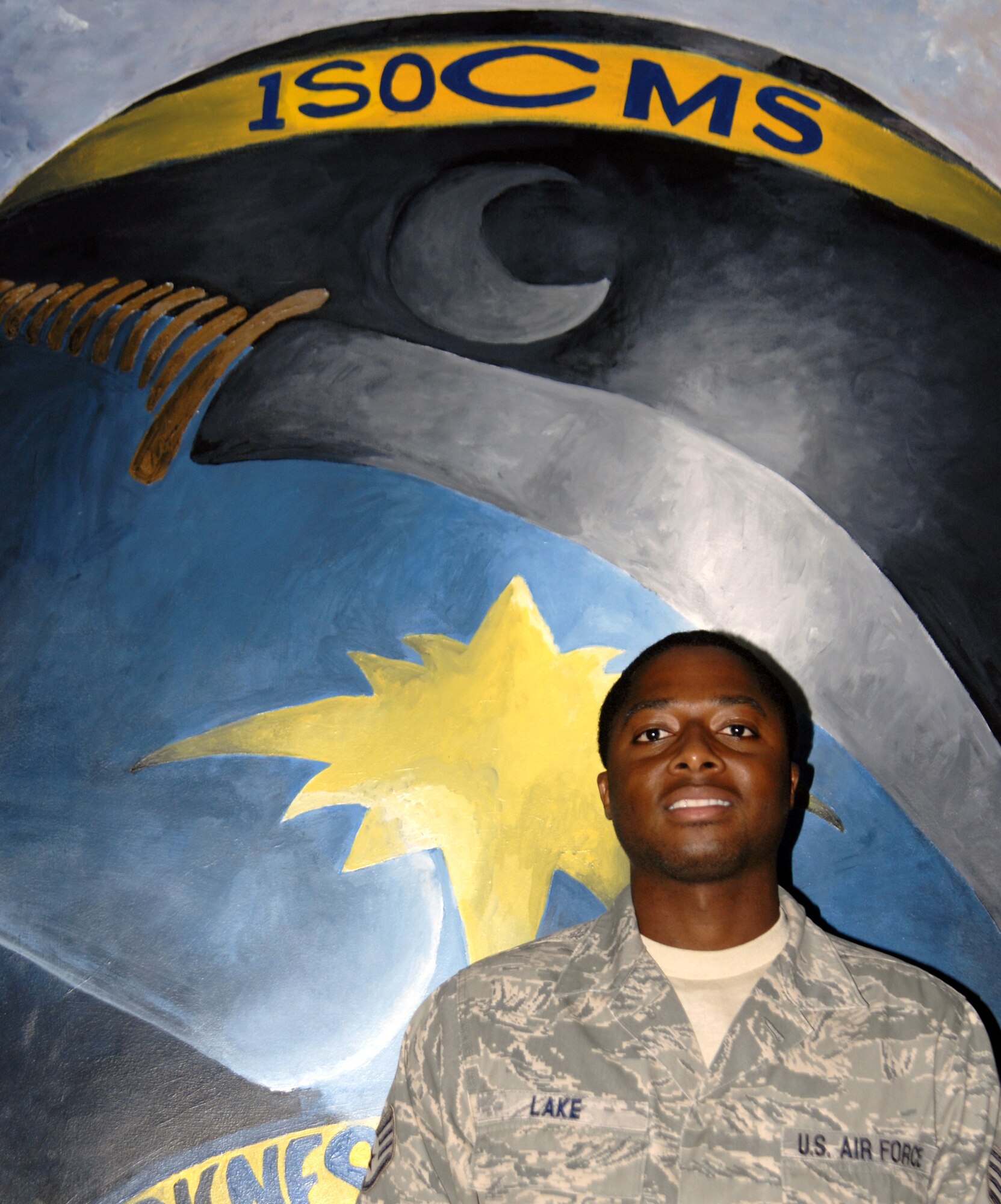 Staff Sgt. Lavel Lake, 1st Special Operations Component Maintenance Squadron supply NCO in charge, poses in front of the 1st SOCMS squadron logo mural at the 1st SOCMS at Hurlburt Field, Fla., Sept. 8, 2010. Sergeant Lake was selected for this week's “Tip of the Spear” spotlight. (DoD photo by U.S. Air Force Staff Sgt. Sarah Martinez) (RELEASED)