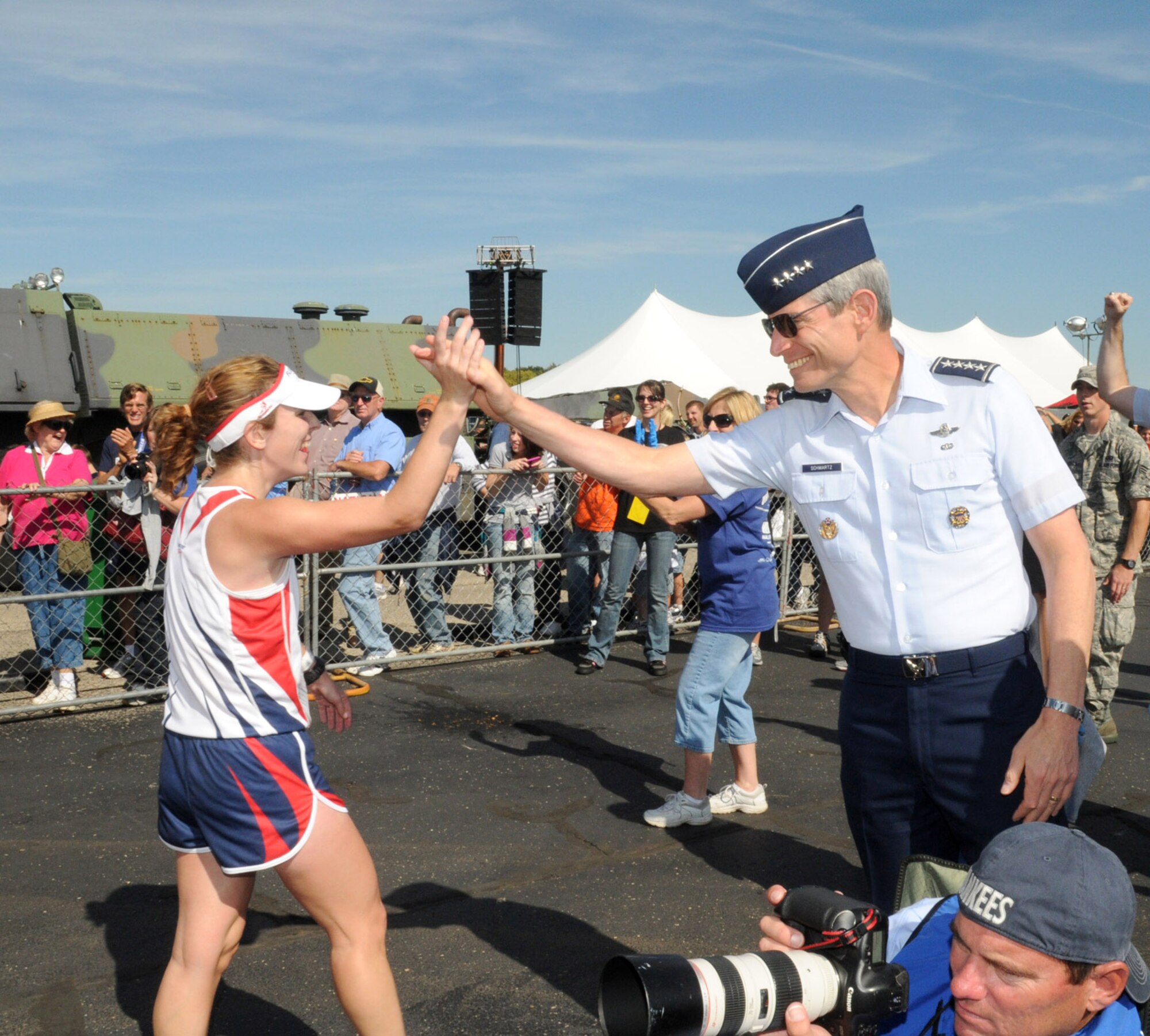 Air Force Chief of Staff Gen. Norton Schwartz, seen here congratulating a runner at last year's Air Force Marathon, plans to run in this year's 10K race at the 14th annual event  Sept. 18, 2010, at Wright-Patterson Air Force Base, Ohio. (U.S. Air Force photo)