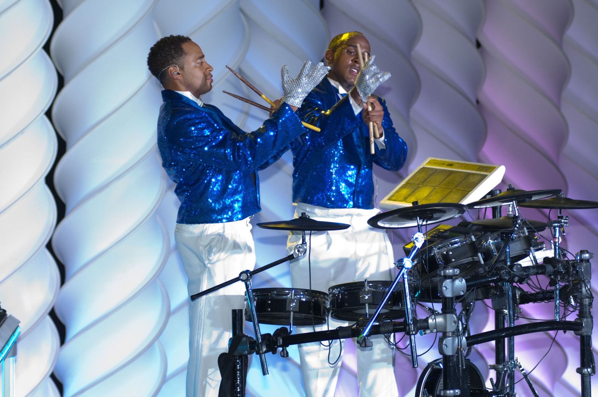 LOWELL, Mass. – Airman 1st Class Jonathan Velasquez and Senior Airman Breyson Robinson put on gloves prior to having a “drum battle” during the Tops in Blue performance at Lowell Memorial Auditorium on Sept. 1. The group is composed of some of the most talented musicians, vocalists dancers and technicians throughout the Air Force. (U.S. Air Force photo by Rick Berry)