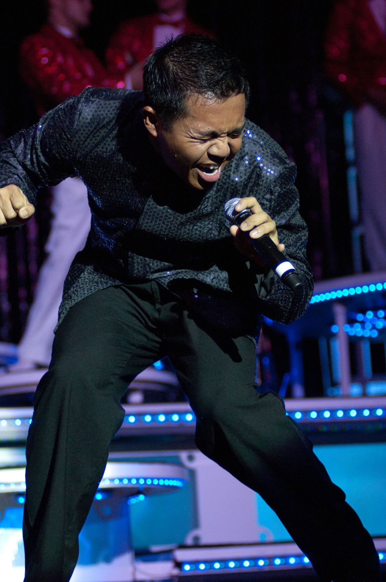 LOWELL, Mass. – Staff Sgt. Harron Elloso belts out a note during the Tops in Blue show on Sept. 1 at Lowell Memorial Auditorium. Sergeant Elloso, along with nearly 40 other Air Force Tops in Blue members, will travel the globe in ten months as goodwill ambassadors for the U.S. Air Force and nation. (U.S. Air Force photo by Rick Berry)