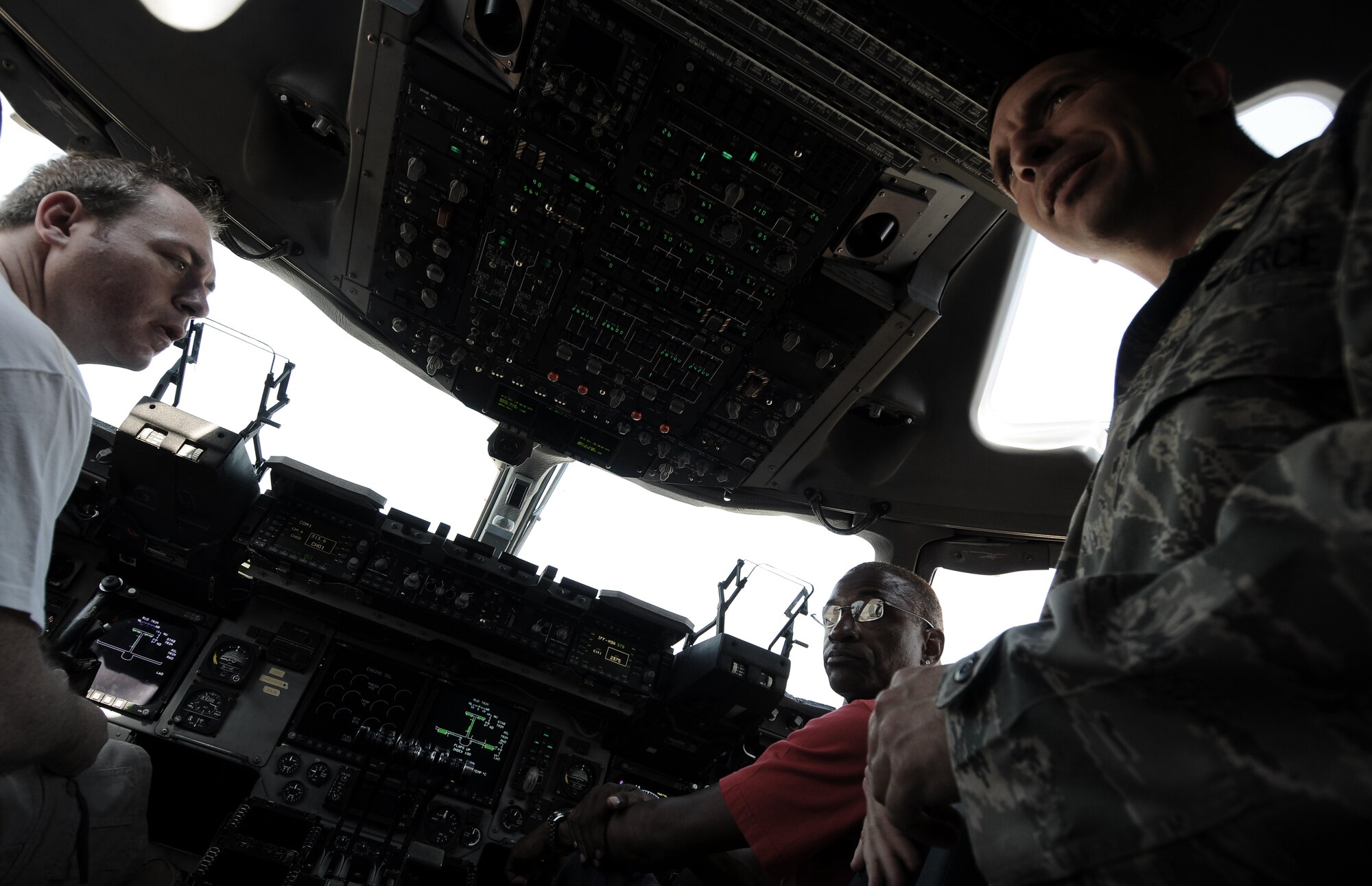 Captain Matthew Dibble, 817th Air Expeditionary Group, explains the flight deck of a C-17 aircraft to comedians’ Robert Maher and Tommy Davidson August 24, 2010 at Incirlik Air Base, Turkey. The comedians brought laughter to the Incirlik community as part of an Armed Force Entertainment tour where they spent a day visiting with Airmen, signing autographs and closing out with stand up performances.  (U.S. Air Force photo by Senior Airman Alexandre Montes/Released)
