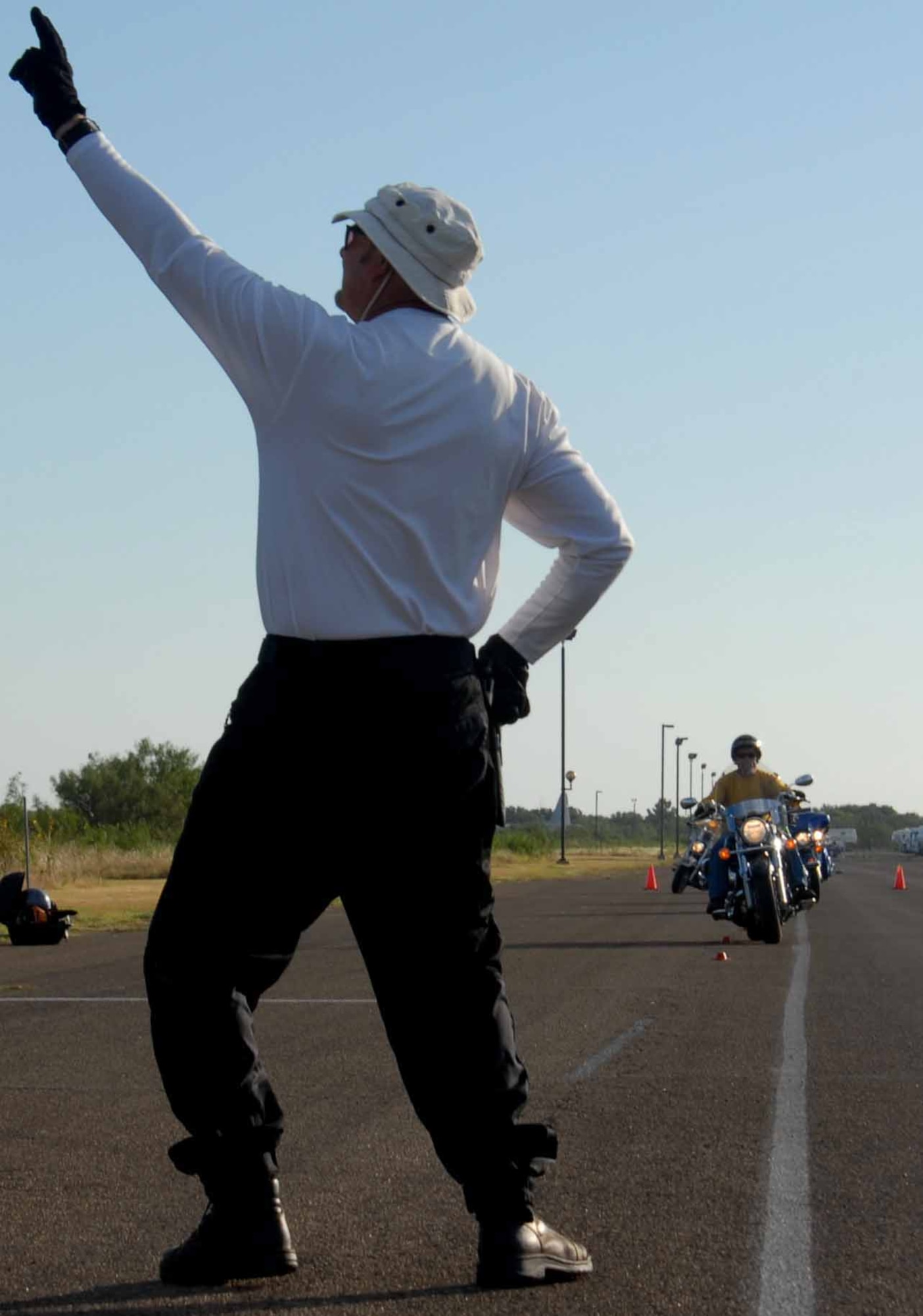 GOODFELLOW AIR FORCE BASE, Texas -- Marshall Munce, gives Peter Nusskern, 17th Training Squadron, instructions during a Experienced Riders Course on base, Aug. 22. The program is free to military and allows riders to practice clutch control, pause and go’s, and weaving around and over obstacles in a controlled environment. The course is taught by Southwest Motorcycle Trainer of San Antonio. For more information, contact a unit motorcycle safety representative. (U.S. Air Force photo/ Senior Airman Tong Duong) 