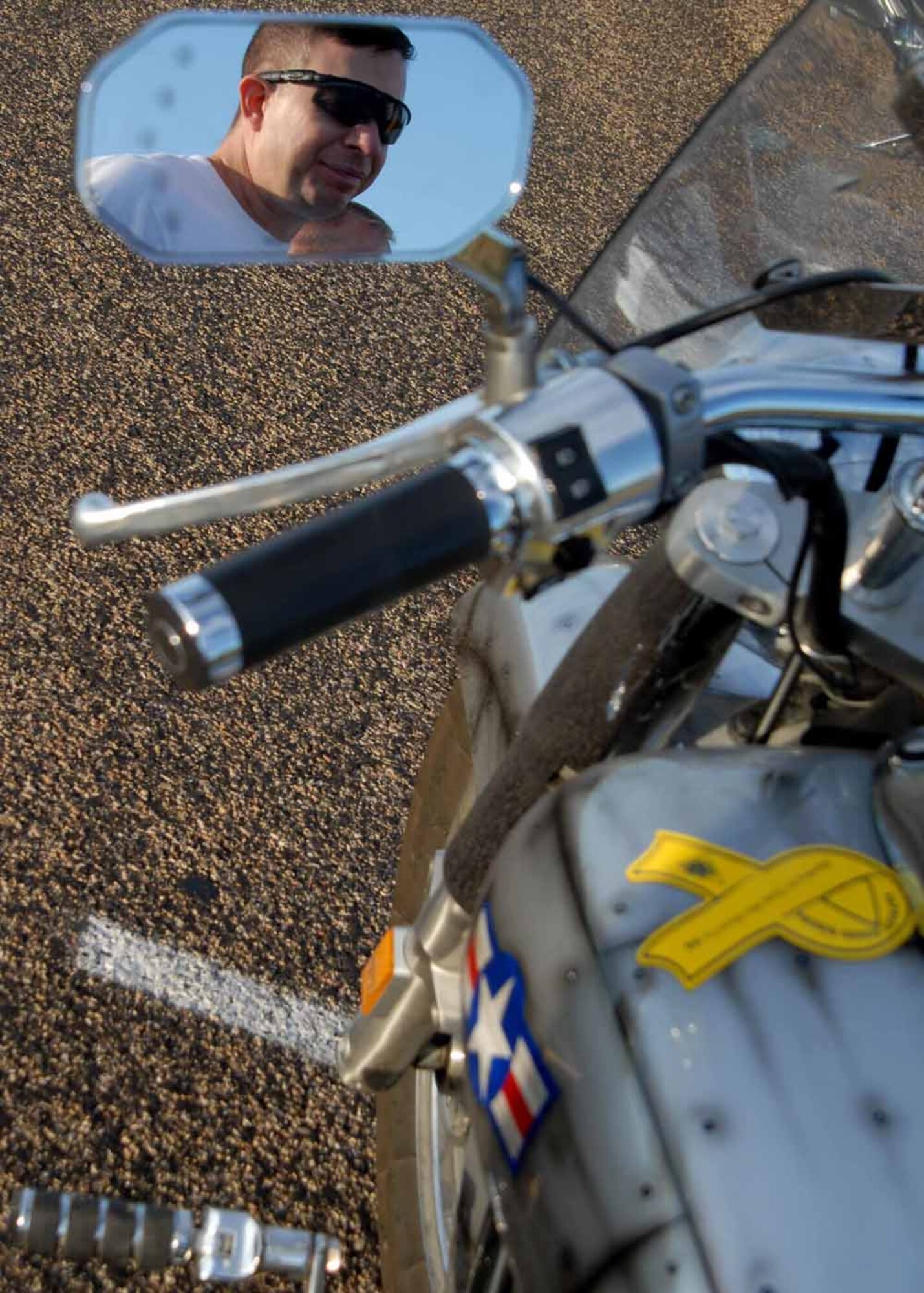 GOODFELLOW AIR FORCE BASE, Texas -- Chief Master Sgt. Brendan Criswell, 17th Training Wing command chief checks out a motorcycle before an Experienced Riders Course on base Aug. 22. The program is free to military, and allows riders to practice clutch control, pause and go’s, and weaving around and over obstacles in a controlled environment. The course is taught by Southwest Motorcycle Trainer of San Antonio. For more information, contact a unit motorcycle safety representative. (U.S. Air Force photo/ Senior Airman Tong Duong) 