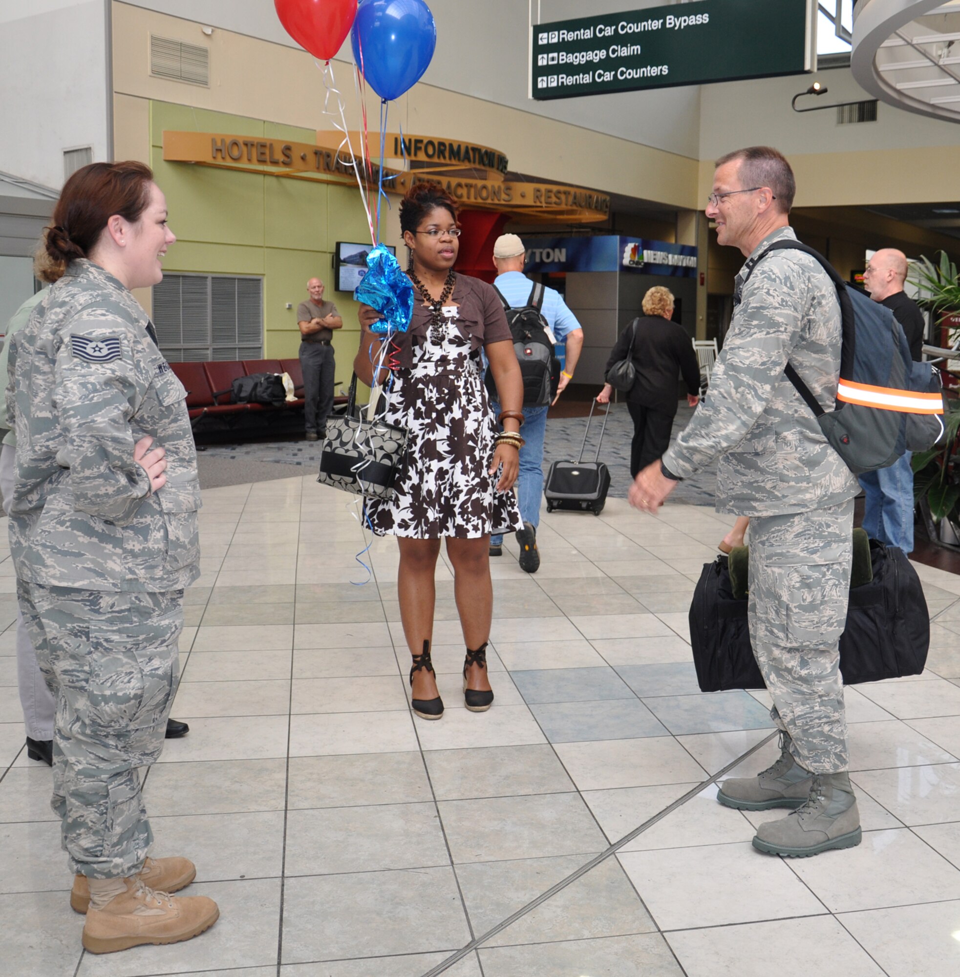 WRIGHT-PATTERSON AIR FORCE BASE, Ohio – Capt. Rodney McNany, 445th Public Affairs, is greeted by Tech. Sgt. Julie Weckerlein and Ms. Shamae Jones, both from 445th Airlift Wing Public Affairs, at the Dayton International Airport Sept. 7 after returning from a 6-month deployment to Southwest Asia. Captain McNany was assigned to the Joint Operations Center for United States Forces, Iraq. (U.S. Air Force photo/Maj. Jose Cardenas)