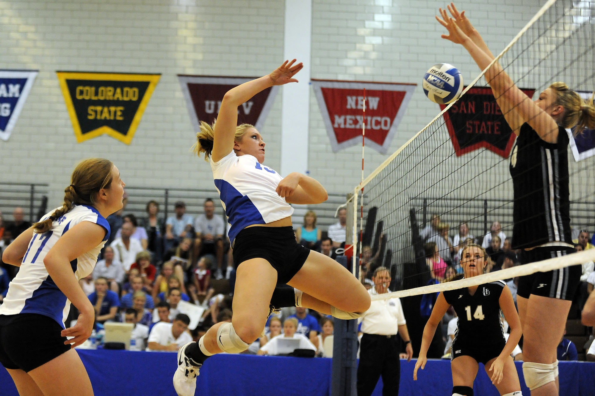 Falcon Caitie Campbell tries to spike the ball over the net during the second game of their season opener against Long Island College Aug. 27, 2010, at the U.S. Air Force Academy in Colorado Springs, Colo. The Falcons won 3-2 over Long Island with scores of 25-14, 22-25, 29-31, 25-19 and 15-9. (U.S. Air Force photo/J. Rachel Spencer)

