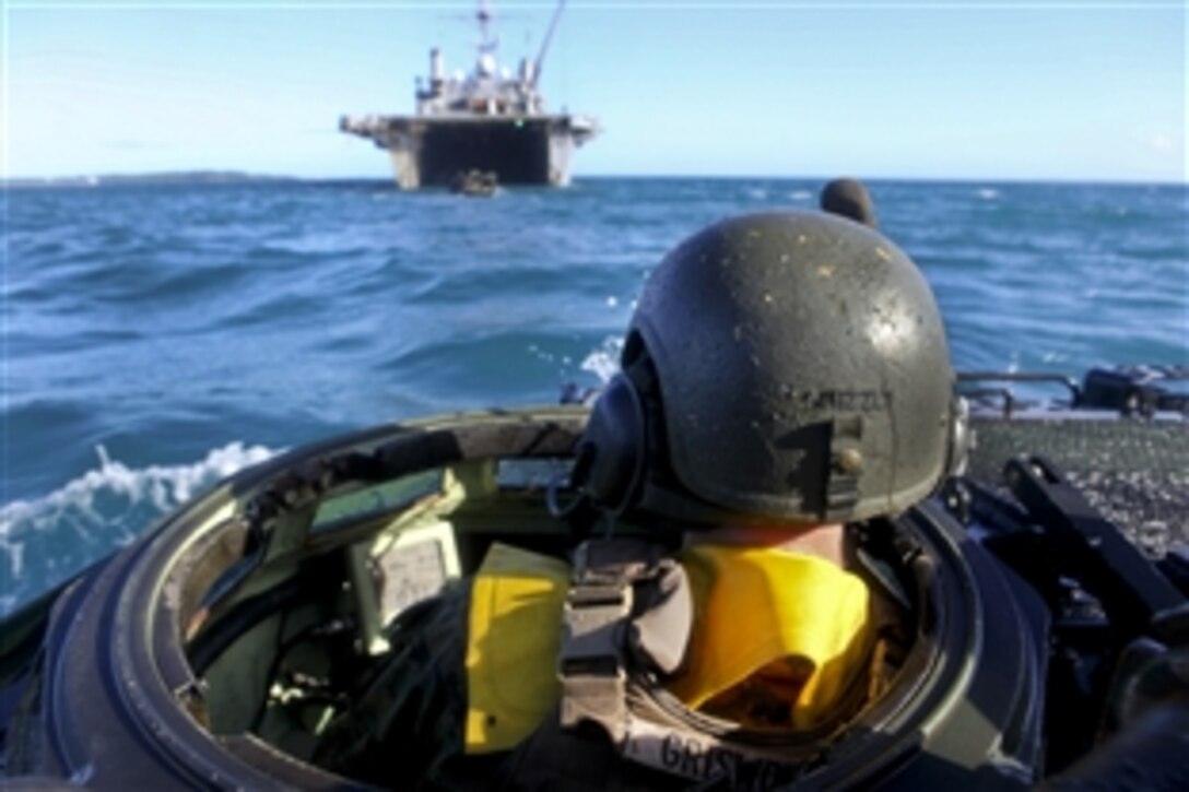 U.S. Marine Corps Cpl. Sean Griswold manuvers his vehicle toward the USS Denver at sea off the coast of Okinawa, Japan, Sept. 7, 2010. Griswold is an amphibious assault vehicle driver assigned to the 1st Battalion Landing Team, 7th Marine Regiment, 31st Marine Expeditionary Unit.