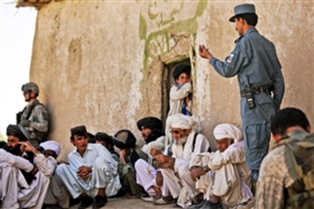 Sardar Mohammed, the police chief of Afghanistan's Shah Joy district, speaks to local elders about security during a shura near Forward Operating Base Bullard, Zabul province, Sept. 2, 2010.