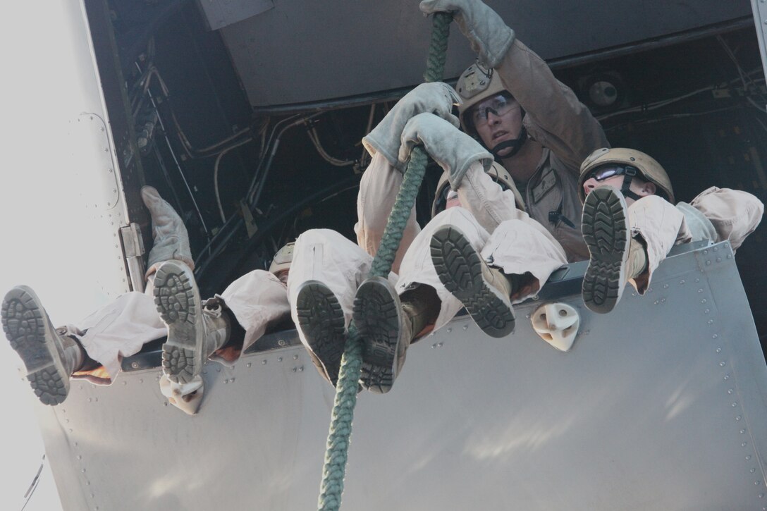 Reconnaissance Marines with Reconnaissance Platoon, Battalion Landing Team 3/8, 26th Marine Expeditionary Unit, sit on the ramp of an MV-22 Osprey prior to fast-roping during a fast-rope qualification exercise aboard USS Kearsarge, Sept. 9, 2010. 26th MEU deployed aboard the ships of Kearsarge Amphibious Ready Group in late August responding to an order by the Secretary of Defense to support Pakistan flood relief efforts.