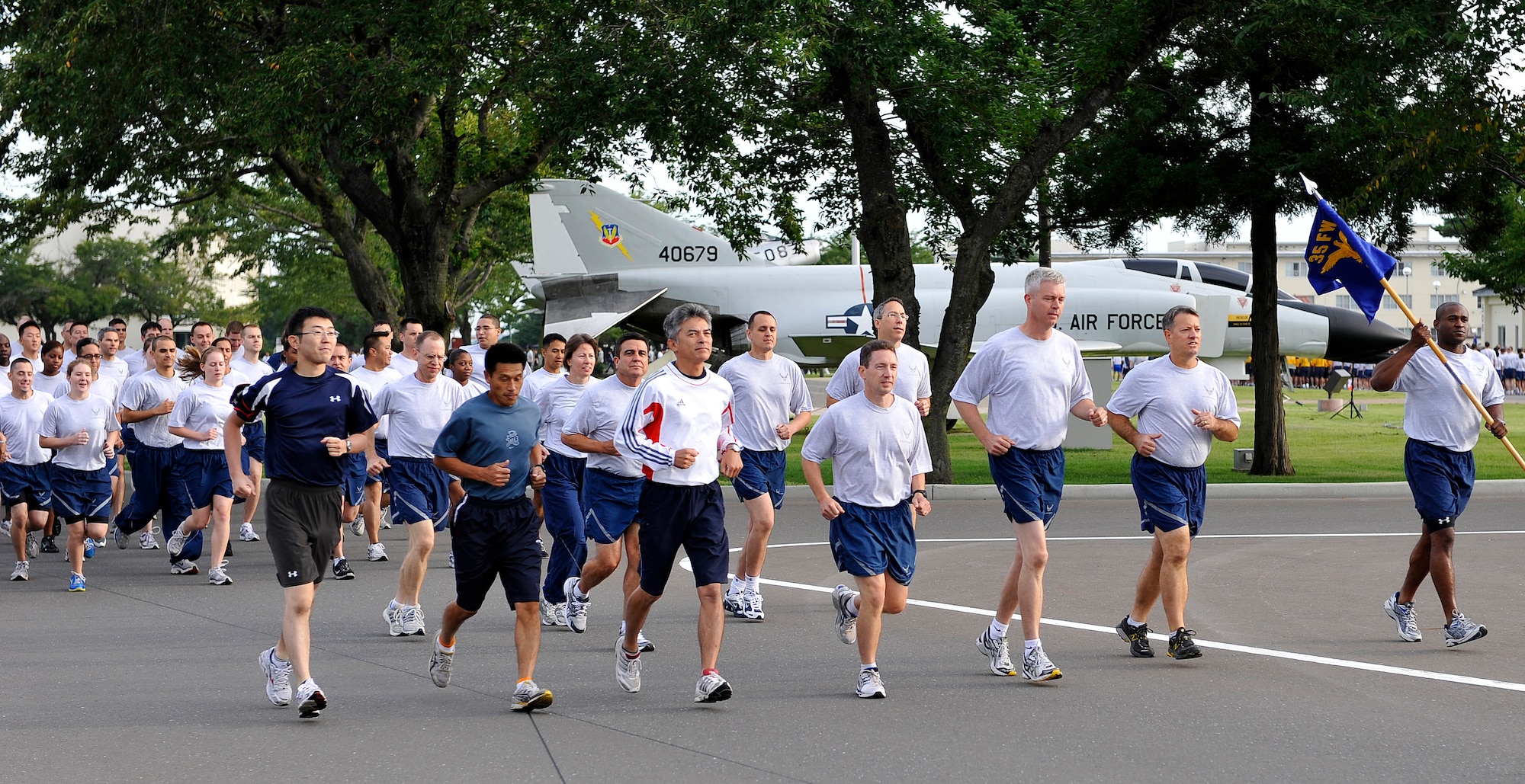 35th Fighter Wing leadership runs side-by-side with Japan Air Self-Defense Force leadership during the monthly readiness run Sept. 10, 2010. Nine units and squadrons participated in the event to promote espirit de corps. (U.S. Air Force photo/Staff Sgt. Chad C. Strohmeyer)(RELEASED)