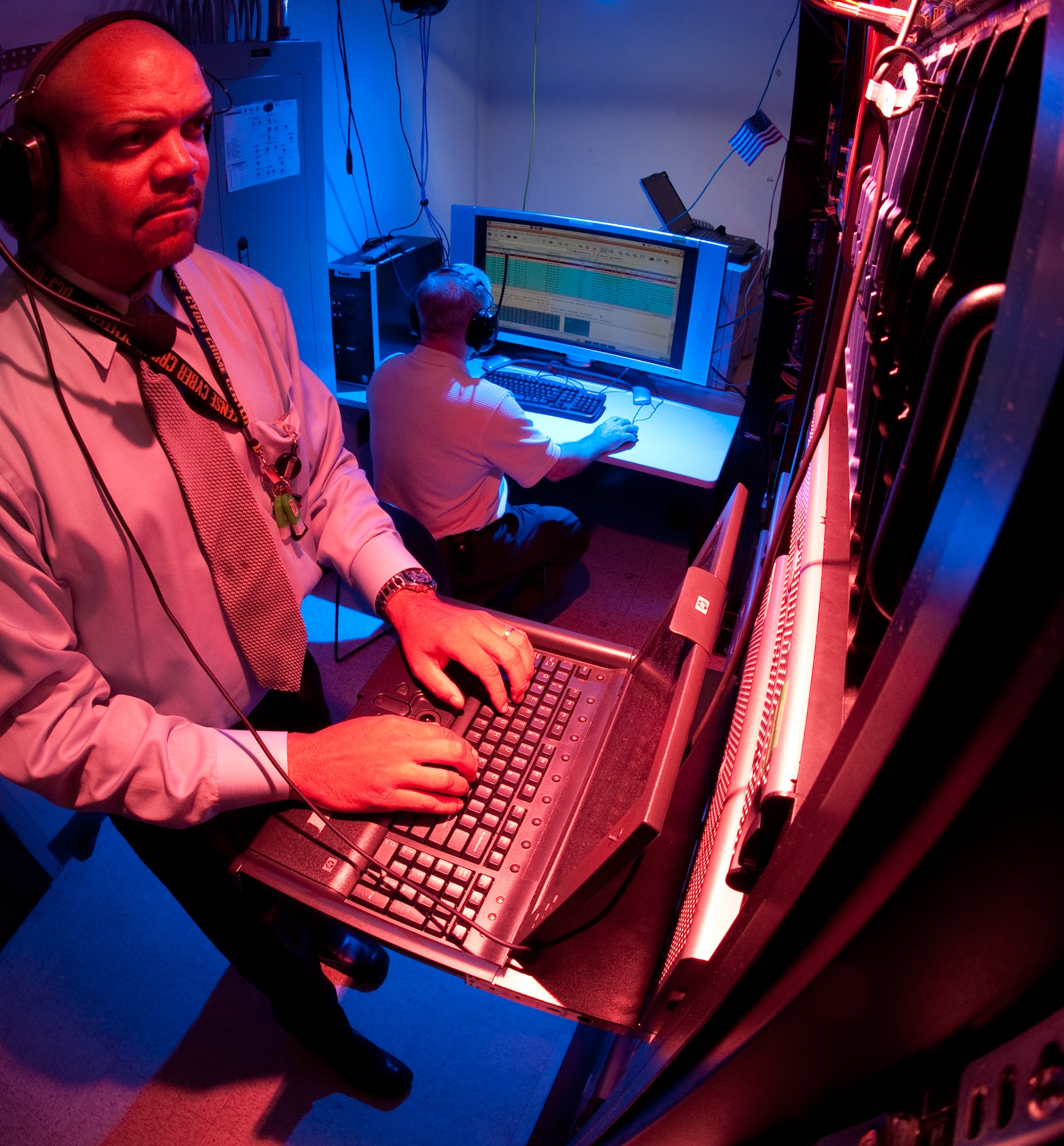 Malcolm Smith (standing) and Mark Neno perform an operational check on various servers in the live network acquisition classroom  for an up coming CAPSTONE event Sept. 9, 2010, at the Defense Cyber Investigations Training Academy in Linthicum, Md.  Mr. Smith is the forensic track manager and Mr. Neno is a forensic track instructor.(U.S. Air Force photo/Lance Cheung)
