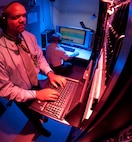 Malcolm Smith (standing) and Mark Neno perform an operational check on various servers in the live network acquisition classroom  for an up coming CAPSTONE event Sept. 9, 2010, at the Defense Cyber Investigations Training Academy in Linthicum, Md.  Mr. Smith is the forensic track manager and Mr. Neno is a forensic track instructor.(U.S. Air Force photo/Lance Cheung)
