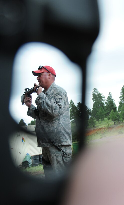 U.S. Air Force Master Sgt. Charles Griffin, 161st Security Forces Squadron Combat Arms Training instructor, teaches a weapons class to Air National Guard members at Camp Navajo in Bellemont, Ariz., August 27, 2010. Sergeant Griffin teaches that breathing techniques and sight alignment are key to a successful day on the range. (U.S. Air Force Photo by Senior Airman Nicole Enos) 