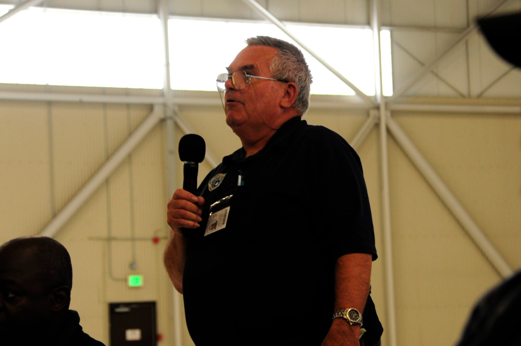 An attendee of the Joint Skies Seminar discusses topics such as safety concerns and flight patterns Sept. 9 at Joint Base Lewis-McChord, Wash. The Joint Skies Seminar was the first of its kind nationwide, bridging the information gap between civilian and military flying. (U.S. Air Force Photo/Airman Leah Young)