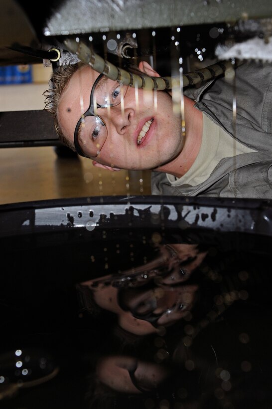 ELLSWORTH AIR FORCE BASE, S.D. - Airman 1st Class Robert Lyde, 28th Maintenance Squadron aerospace ground equipment technician, changes the oil of a hydraulic test stand, Sept. 7.  The hydraulic test stand provides pressurized hydraulic fluid to aircraft, which is necessary to run flight controls for maintenance purposes. (U.S. Air Force photo/Staff Sgt. Marc I. Lane)