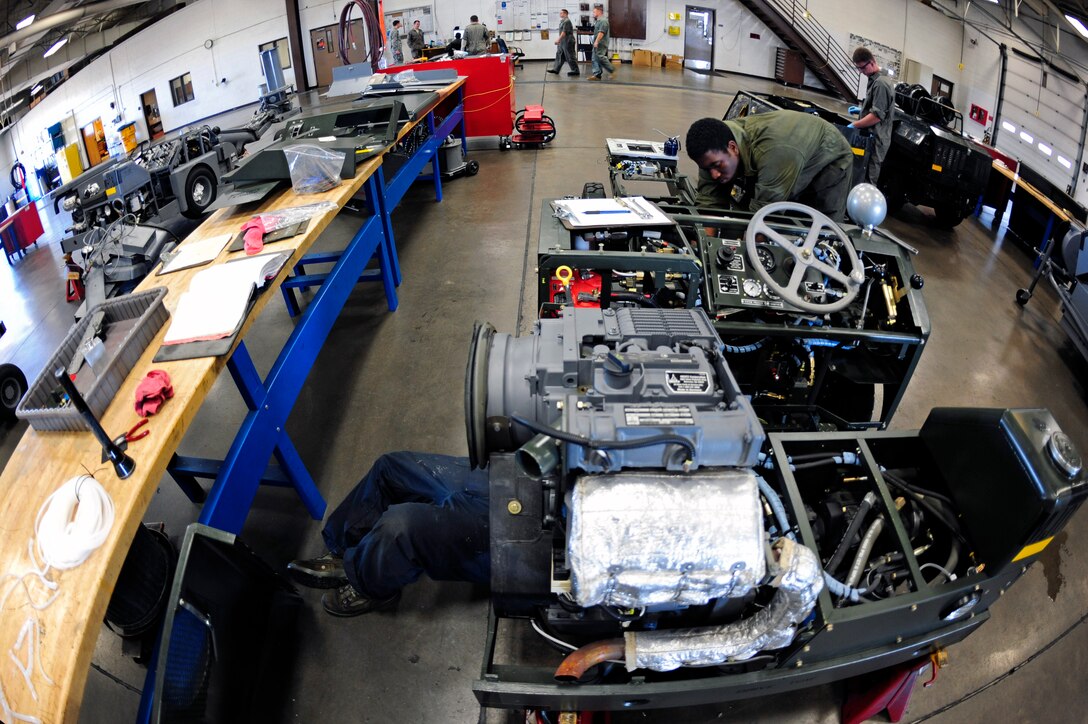 ELLSWORTH AIR FORCE BASE, S.D. - Airmen of the 28th Maintenance Squadron aerospace ground equipment section work on various projects, Sept. 7.  Aerospace ground equipment technicians service, inspect, troubleshoot, repair and perform preventive maintenance on motor and engine-driven generator sets, air conditioners, hydraulic test stands, air compressors, bomb lifts, heaters and other similar support equipment. (U.S. Air Force photo/Staff Sgt. Marc I. Lane)