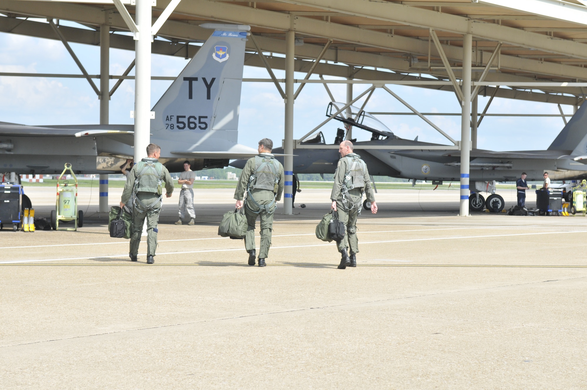 Captain David Magnuson, Lt. Col. Scott Yancy and Lt. Col. Brian Porter walk toward the F-15s to fly their fini flight Sept. 7 at Tyndall Air Force Base, Fla.  (U.S. Air Force photo/Susan Trahan)