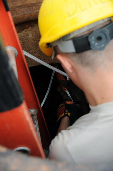 BARKSDALE AIR FORCE BASE, La. -- Airman 1st Class David Montroy, 2nd Communications Squadron antenna systems apprentice removes excess innerduct Sept. 9. The 2nd CS most important role is ensuring that the critical systems providing the command and control path for Barksdale?s combatant forces are always ready. (U.S. Air Force photo by Senior Airman Brittany Y. Bateman)(RELEASED)