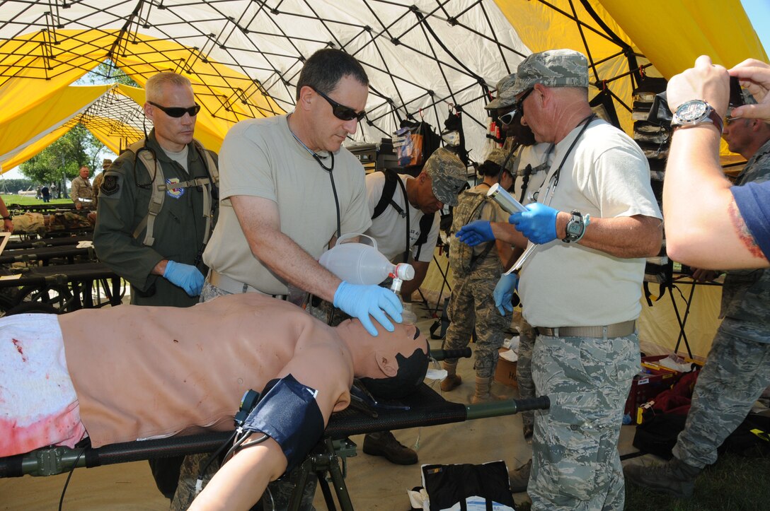 U.S. Airmen from the 142nd Medical Group join members of the 181st Medical Group and medics from Canada July 15, 2010, at Volk Field, Wis., during Patriot 2010. Patriot is a joint force exercise that helps train and hone aeromedical skills. (U.S. Air Force photo by Staff Sgt. Ann Fitzgerald/Released) 