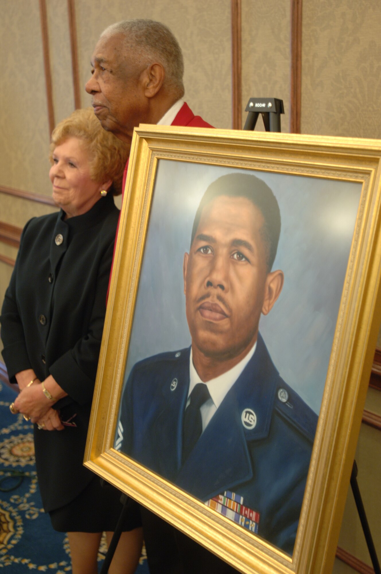 LANGLEY AIR FORCE BASE, Va. -- Retired Chief Master Sgt. Grant S. Williams, Sr., a Documented Original Tuskegee Airman, poses for photos with guests alongside his official portrait following his induction into the Langley Chief’s Room at the Bayside Enlisted Club Sept. 9. Williams remains active in the Air Force community, making frequent public speaking appearances nationwide and fundraising for scholarships for high school students pursuing degrees in science and aviation. (U.S. Air Force photo/Airman 1st Class Jason J. Brown) (RELEASED)