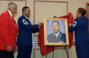 LANGLEY AIR FORCE BASE, Va. -- Retired Chief Master Sgt. Grant S. Williams, Sr. looks on as Chief Master Sgts. Maurice James and Vernitia Johnson unveil Williams’s official portrait during his induction into the Langley Chief’s Room at the Bayside Enlisted Club Sept. 9. Williams is a Documented Original Tuskegee Airman who settled in Hampton, Va. following a 33-year military career. (U.S. Air Force photo/Airman 1st Class Jason J. Brown) (RELEASED)