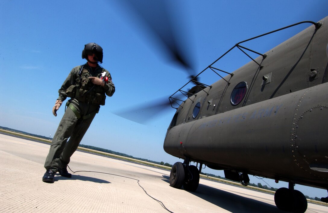 SSg Justin Hinderliter, flight engineer, CH-46D Chinook does a way around inspection during an engine start at PATRIOT 2006, Volk Field, WI., July 18, 2006. PATRIOT is the premier National Guard Bureau sponsored joint exercise. This exercise increases the warfighting capabilities of the National Guard, reserve, and active components of the Air Force and Army. Additionally, Canadian, United Kingdom, and Dutch forces are participating, increasing combined effectiveness. (US Air Force photo by MSgt Robert A. Whitehead) (Released). 
