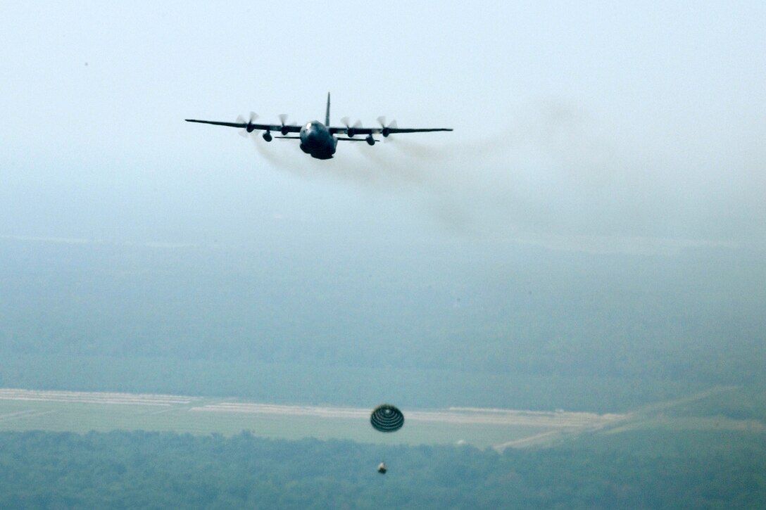 A U.S. Air Force C-130 Hercules aircraft, assigned to the 192nd Airlift Squadron, 152nd Airlift Wing, Nevada Air National Guard, drops cargo over Volk Field, Wis., July 19, 2006, during exercise Patriot 2006. Patriot is a large-scale National Guard Bureau-sponsored field exercise designed to increase the warfighting capabilities of National Guard, reserve and active components of the U.S. Air Force, the U.S. Army and participating foreign military service members from Canada, the United Kingdom and the Netherlands. (U.S. Air Force photo by Master Sgt. Robert A. Whitehead/Released) 