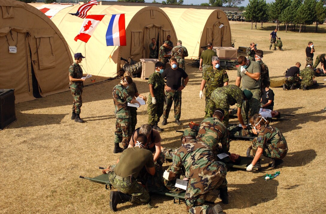 American, Canadian, and Dutch medical teams triage patients during a mass casualty exercise to provide the best medical care at the field hospital. Personnel from the 152nd Medical Squadron, Nevada Air National Guard; 166th Medical/Dental Squadron, Delaware Air National Guard; and medical personnel from across Canada and the Netherlands joined forces at Volk Field, Wis., to form an internationally staffed field hospital. Patriot 05 is the largest annual exercise held across the United States. This exercise increases the war fighting capabilities of the National Guard, Reserve, and active components of the Air Force and Army. Additionally, Canadian, United Kingdom, and Dutch forces are participating, increasing combined effectiveness. (U.S. Air Force photo by Tech. Sgt. Robert Jones) (Released) 