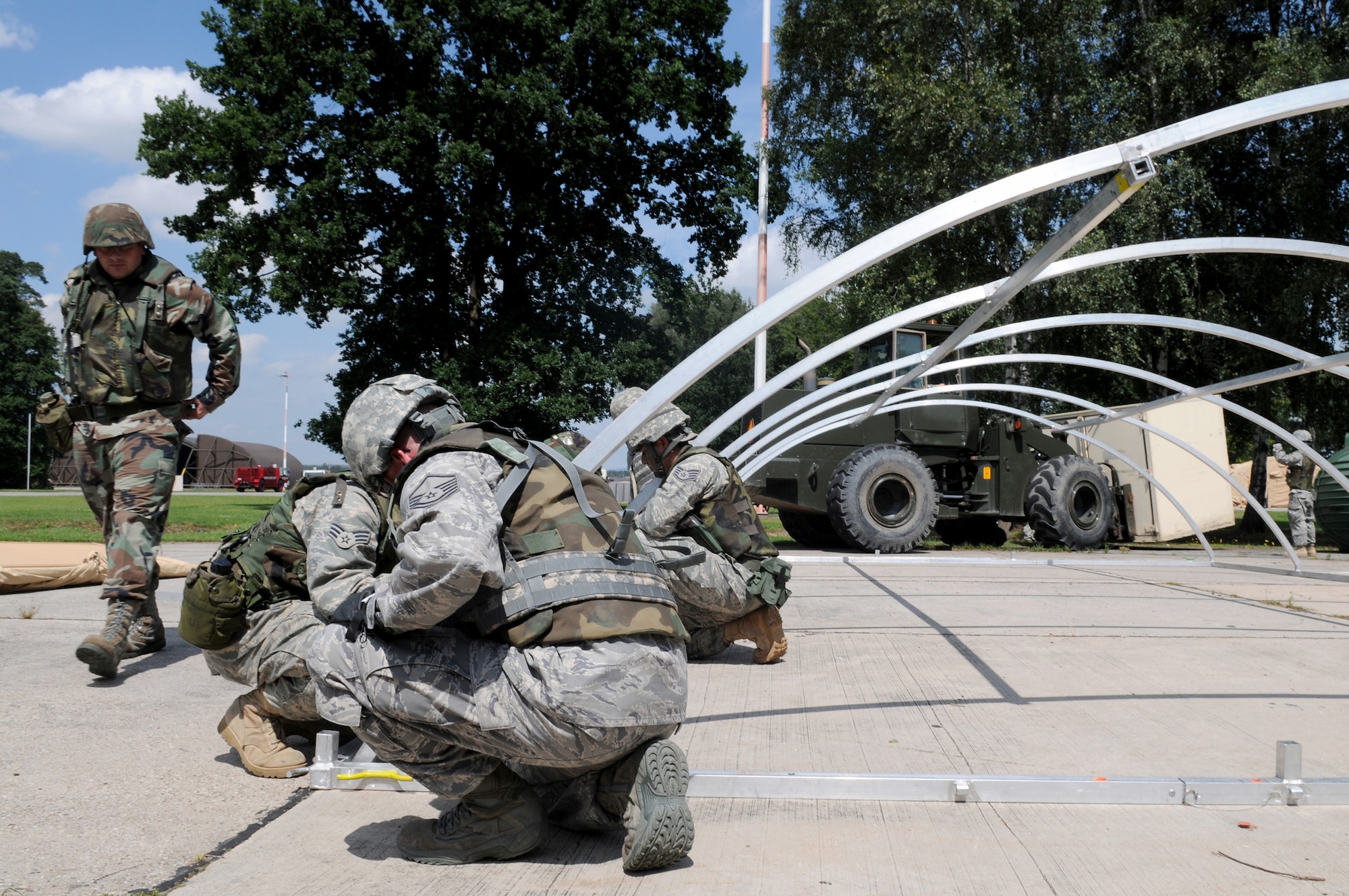Airmen work together to build small shelter-system tents during a Silver Flag exercise at the 435th Construction and Training Squadron contingency training site at Ramstein Air Base, Germany. The 435th CTS celebrates its 60th anniversary Sept. 10, 2010, at Ramstein Air Base, Germany. (U.S. Air Force photo/Airman 1st Class Grovert Fuentes-Contreras)