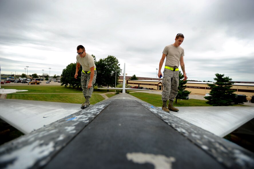 Staff Sgt. Seth Lemonds, (left) and Airman 1st Class Kyle Miller, 509th Maintenance Squadron, inspect the top of a B-47 Stratojet static display aircraft before performing maintenance on it, Wednesday. The B-47 never saw combat as a bomber, but was a mainstay of Strategic Air Command bomber strength during the 1950s and early 1960s, and remained in use as a bomber until 1965. (U.S. Air Force photo Senior Airman Kenny Holston)(Released)