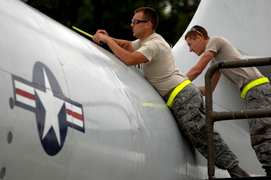 Staff Sgt. Seth Lemonds, (left) and Airman 1st Class Kyle Miller, 509th Maintenance Squadron, take measurements of damaged areas on a B-47 Stratojet static display aircraft, Wednesday. The B-47 arose from an informal 1943 requirement for a jet-powered reconnaissance bomber, drawn up by the U.S. Army Air Forces to prompt manufacturers to start research into jet bombers. (U.S. Air Force photo Senior Airman Kenny Holston)(Released)


