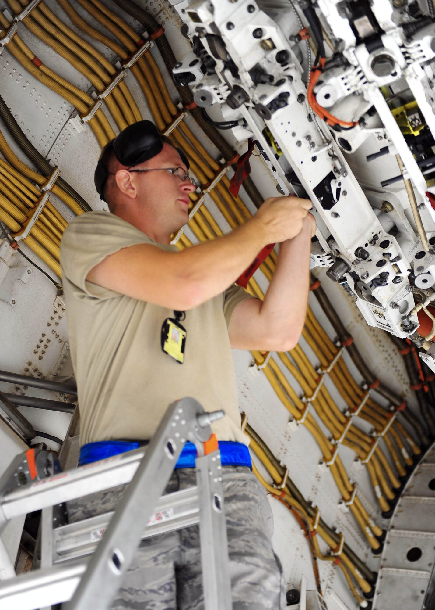 Staff Sgt. Matthew Nichols installs cow bells for a launcher reliability test Sept. 7, 2010, at Dyess Air Force Base, Texas. A Dyess AFB B-1B Lancer carried a full load of 24 AGM-158 Joint Air-to-Surface Stand-off Missiles on a five-hour flight over the Gulf of Mexico -- a first for the B-1 and AGM-158. Sergeant Nichols is assigned to the 7th Airlift Maintenance Squadron. (U.S. Air Force photo/Airman 1st Class Brittney Smolinski) 

