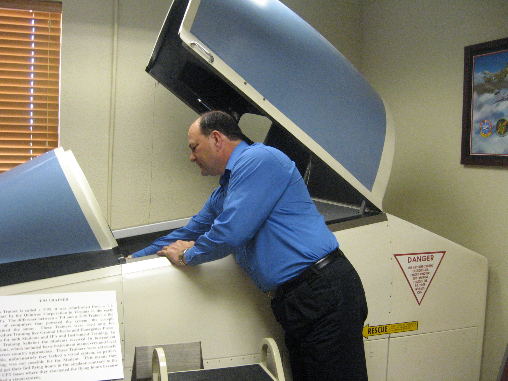 Sheppard Heritage Center Curator George Strader, adjusts the controls of a
mock flight simulator donated by the 80th Flying Training Wing at Sheppard Air Force Base, Texas.  The simulator room is the most recent display available for visiting tour groups.  (U.S. Air Force photo/Debi Smith)
