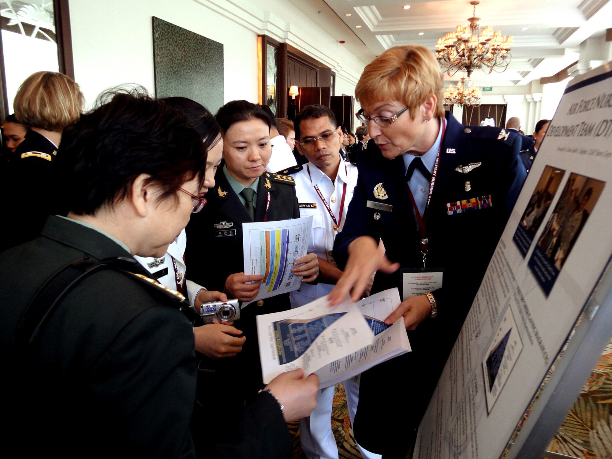 Col. Judith Hughes talks to delegates from China and Indonesia during the 4th annual Asia-Pacific Nursing Conference Symposium, where more than 200 nurses from 13 countries were in attendance. The seven-day conference, hosted by the Armed Forces of the Philippines Office of the Chief Nurse, in collaboration with U.S. Pacific Command and the 13th Air Force, focused on nursing education, career development, global pandemic preparedness and disaster management. Colonel Hughes is the Pacific Air Forces' chief nurse at Joint Base Pearl Harbor-Hickam Hawaii. (U.S. Air Force photo/Tech. Sgt. Carlos Limo) 