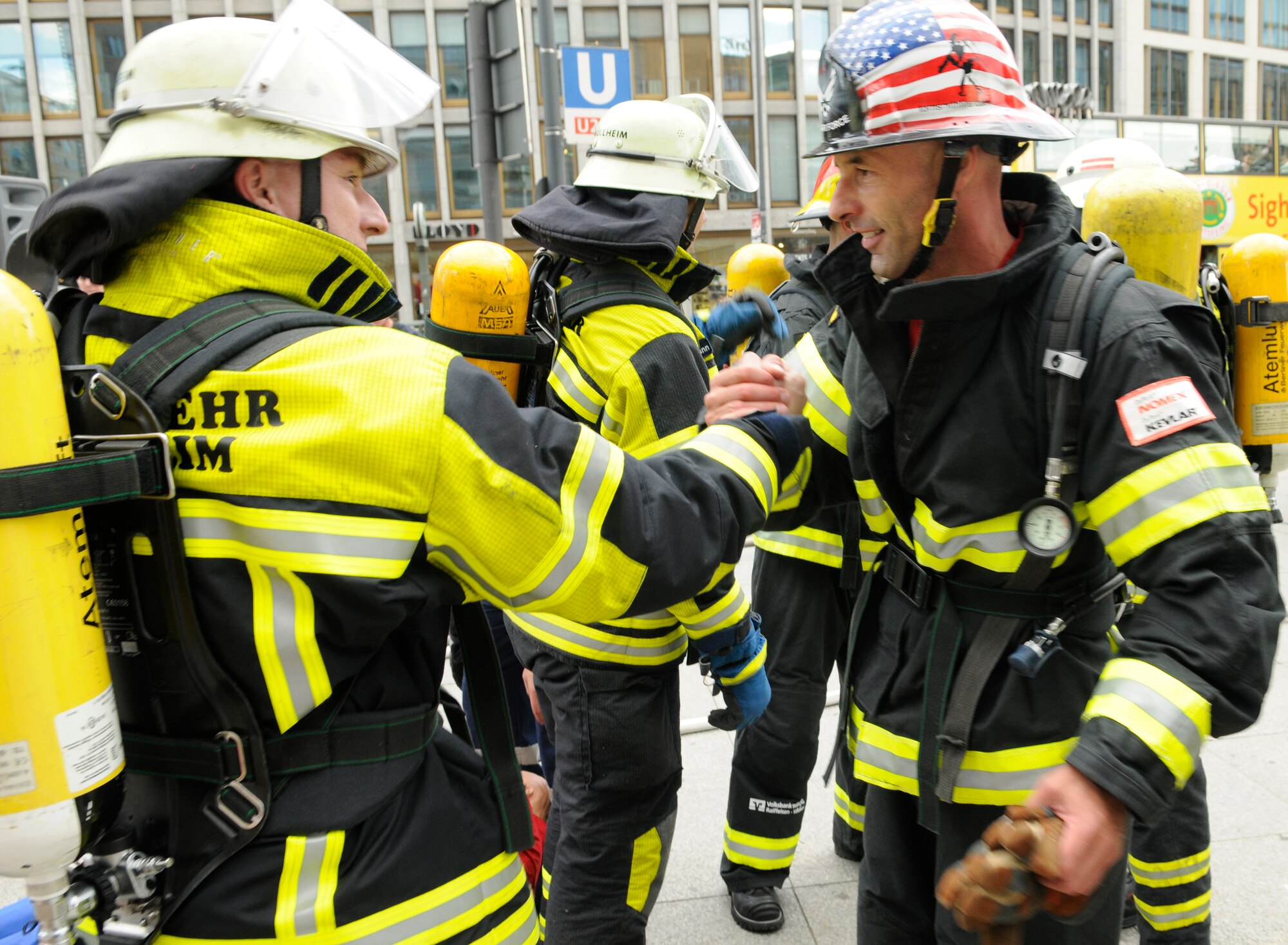 BERLIN – Gerd Mueller, right, 52nd Civil Engineer Squadron fire crew chief, shakes hands with his competitor after a relay race during the fourth Berlin Firefighter Combat Challenge Sept. 3. Mr. Mueller was part of Team Spangdahlem, which finished its race with a time of 1 minute, 48 Seconds, placing third in the qualifying round. (U.S. Air Force photo/Staff Sgt. Benjamin Wilson)