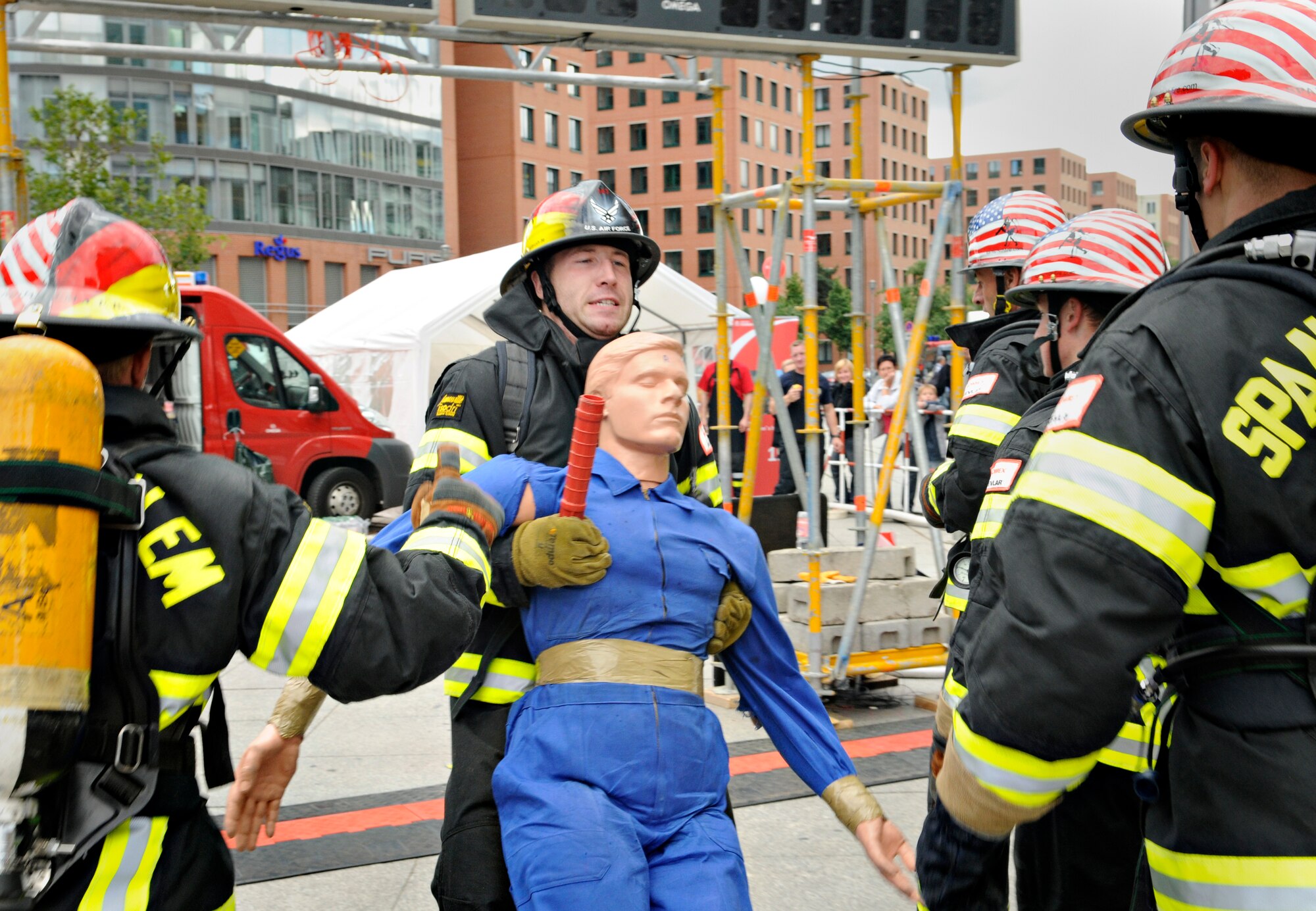 BERLIN – Team Spangdahlem rallies around Staff Sgt. Chastin Warner, 52nd Civil Engineer Squadron firefighter, as he completes the last portion of a relay event during the fourth Berlin Firefighter Combat Challenge Sept. 3. The Berlin FFCC consists of an obstacle course specifically designed to test the physical abilities of a firefighter. (U.S. Air Force photo/Staff Sgt. Benjamin Wilson)
