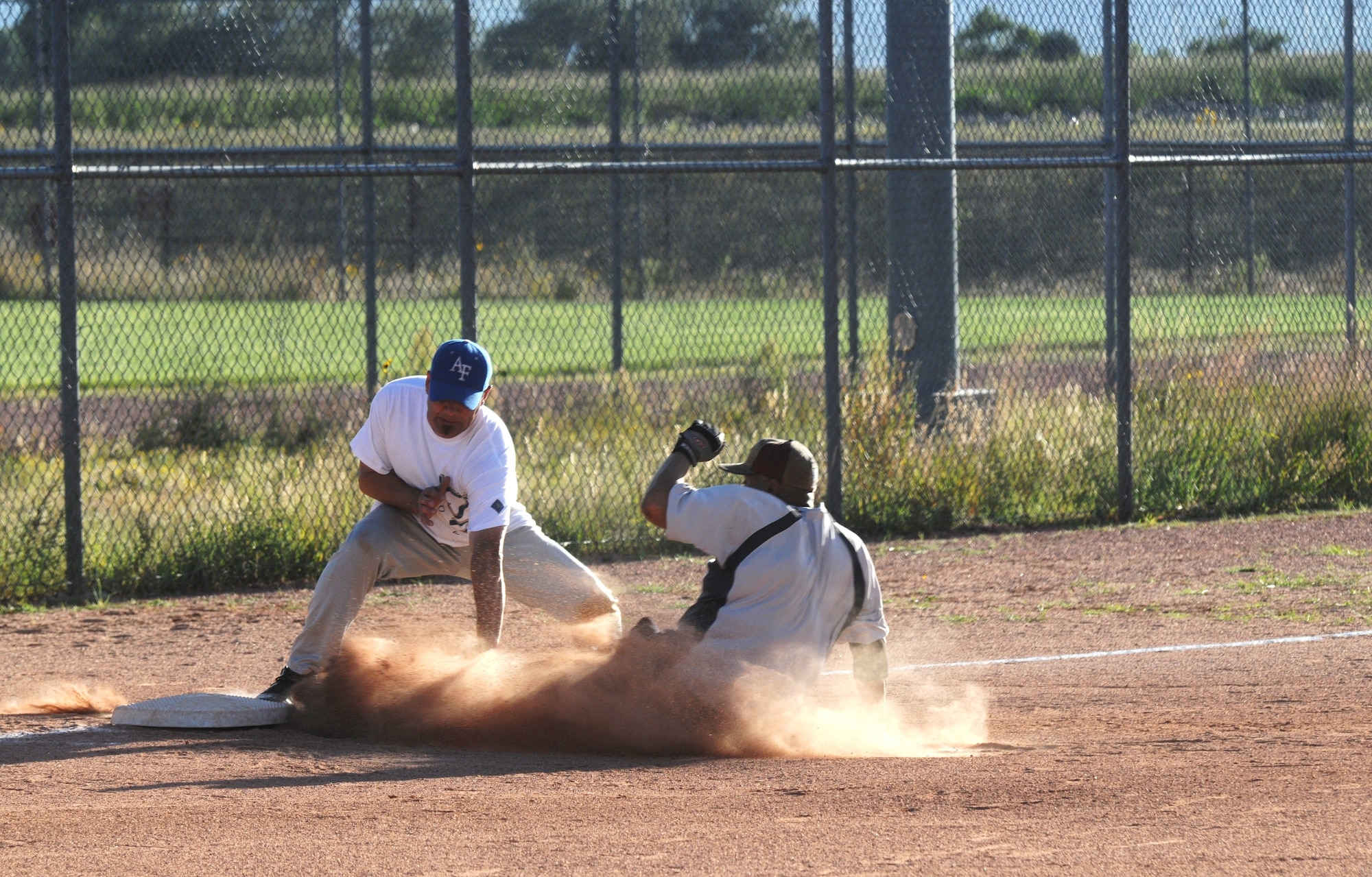 Mike Mouton, 21st Logistics Readiness Squadron, slides into third base during the championship game action Aug. 31 at the Peterson Sports Complex. The 21st LRS overcame tremendous odds to defeat Team Colorado 19-7 and capture the 2010 Peterson Bronze league softball championship. (U.S. Air Force photo/Walt Johnson)
