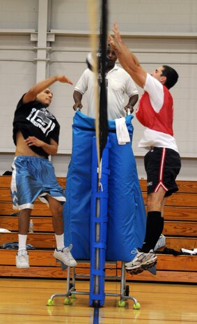 Conrad lopez, left, spikes the ball over the net at 2nd Lieutenant Benjamin Bressler during the Joint Base Charleston intramural volleyball championship game between the 437th Aircraft Maintenance Squadron and the 628th Civil Engineer Squadron at the Fitness and Sports Center Sept. 8, 2010, on Joint Base Charleston, S.C. The game lasted two sets ending with the 437 AMXS as the overall victors for the intramural volleyball season. Mr. Lopez is a family member of Airman 1st Class Sebastiana Solis Lopez and Lieutenant Bressler is an asset manager for the 628th Civil Engineering Squadron. (U.S. Air Force photo/Senior Airman Timothy Taylor)