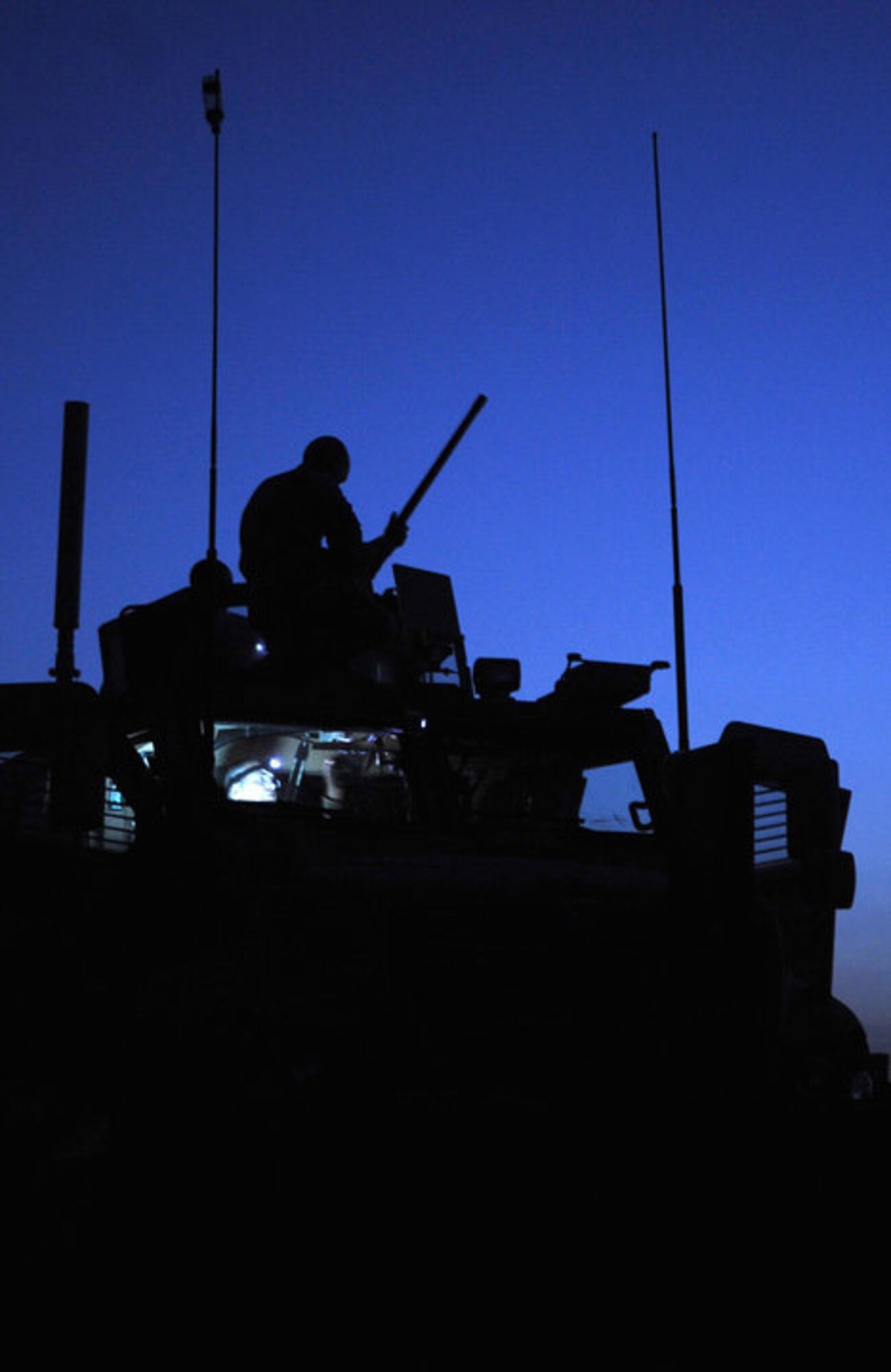 HERAT, AFGHANISTAN -- A soldier from the 82nd Airborne mounts a .50 caliber weapon on top of a mine resistant ambush protected vehicle in preparation for a 400 kilometer convoy to Bala Murghab. Members of the Seymour Johnson community are being asked to submit their photos of daily life in Afghanistan for display consideration in the upcoming Arts Council of Wayne County “A Country, A People” exhibit. The exhibit will showcase native Afghans and military members serving in the country, as well as highlight the culture and personnel experiences through discussion panels, food and music. (U.S. Air Force photo/Senior Airman Makenzie Lang)