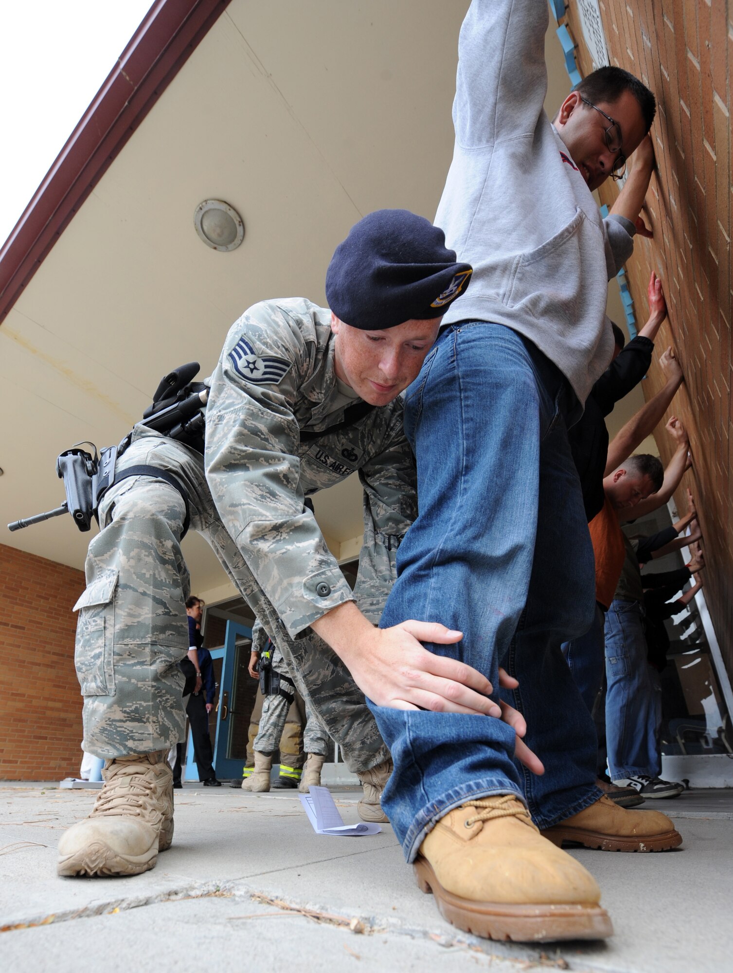 MOUNTAIN HOME AIR FORCE BASE, Idaho – Staff Sgt. Timothy Kennedy, 366th Security Forces Squadron patrolman, frisks victims to be sure no one is armed at the base primary school during an exercise Sept, 8.  Mountain Home AFB uses simulated exercises to increase their readiness and ability to take appropriate measures to protect our people and resources during real-world situations. (U.S. Air Force photo by Senior Airman Debbie Lockhart)